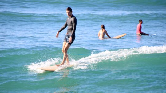 Surfer riding a clean wave at Playa La Lancha in Punta Mita