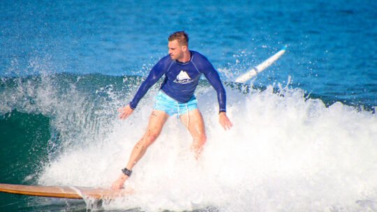 Surfer riding a wave in Sayulita during WildMex Surf Camp session