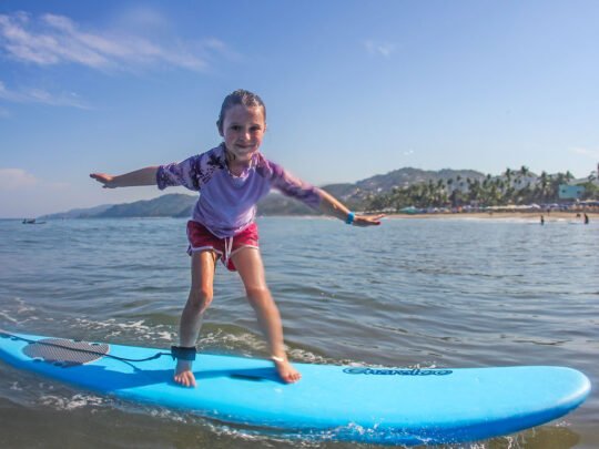 happy surfers after surf lessons in sayulita on the main beach