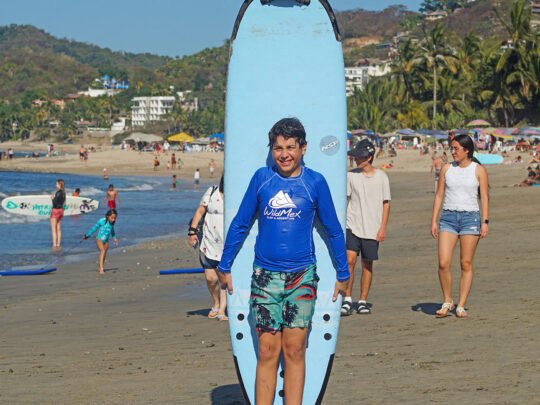 beach warm-up and stretching before surf lessons in sayulita, mexico