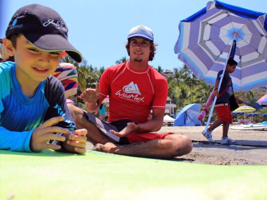 bilingual instructor giving paddling tips in surf lessons in sayulita