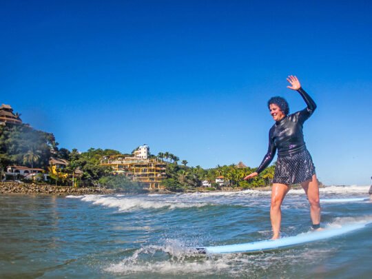 intermediate surfer improving stance and timing during surf lessons in sayulita