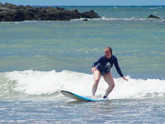 small group catching green waves during surf lessons in sayulita