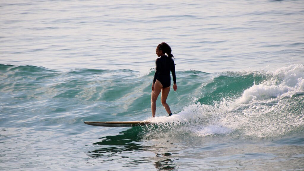 Surfer riding a wave at La Lancha beach during WildMex surf camp session