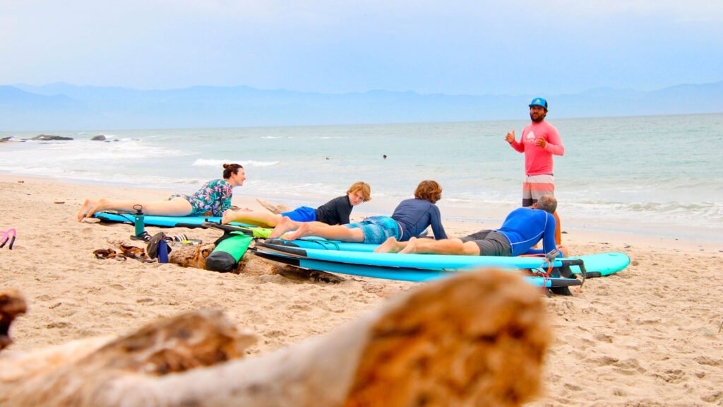 Surf instructor coaching a family during a surf lesson
