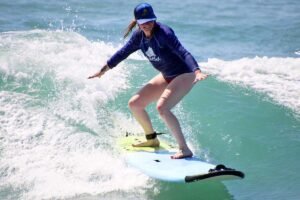 Female surfer riding a wave during WildMex surf photography session in La Lancha