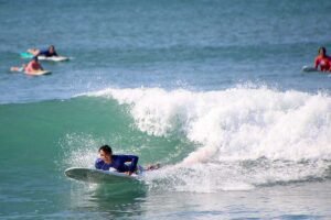 Surfer preparing to catch a wave during WildMex surf photo session