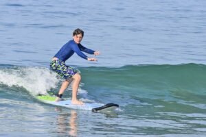 Young surfer riding a wave during WildMex surf shoot in Punta Mita