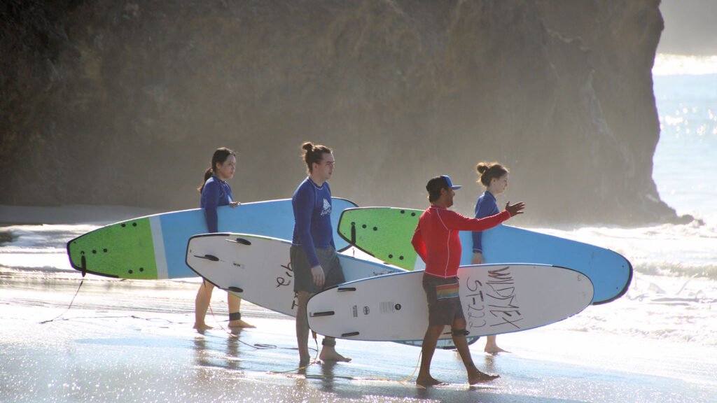 Surf instructor guiding guests along the beach