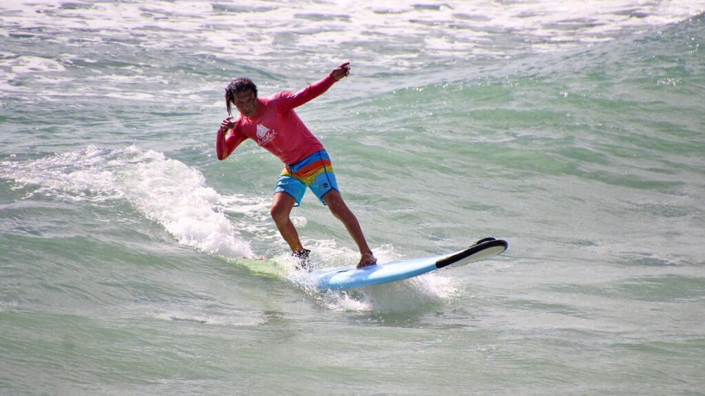 Surf instructor riding a wave in Sayulita