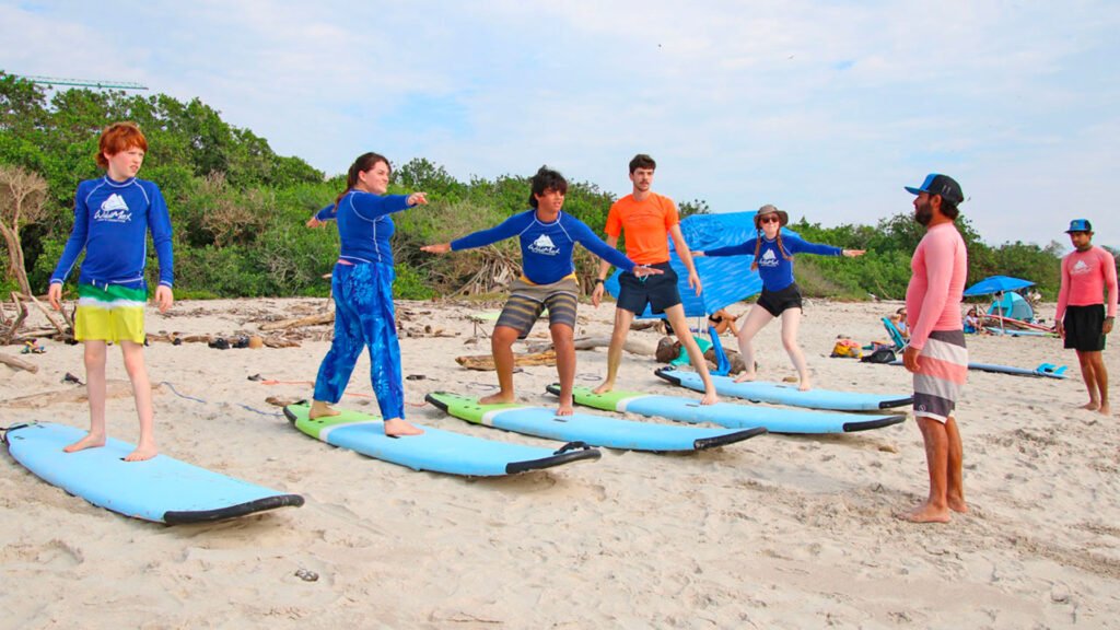 Surf instructor leading a group land session at La Lancha beach