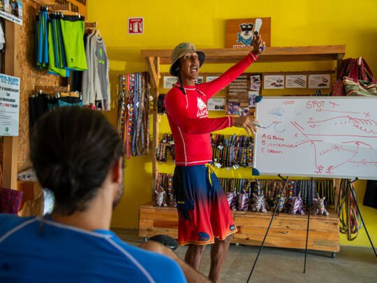WildMex surf instructor giving a theory lesson before coached surf session in Punta Mita
