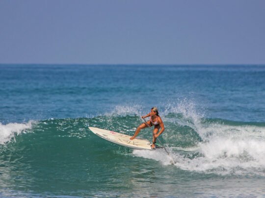 Woman paddle boarding during WildMex SUP lesson in Punta Mita