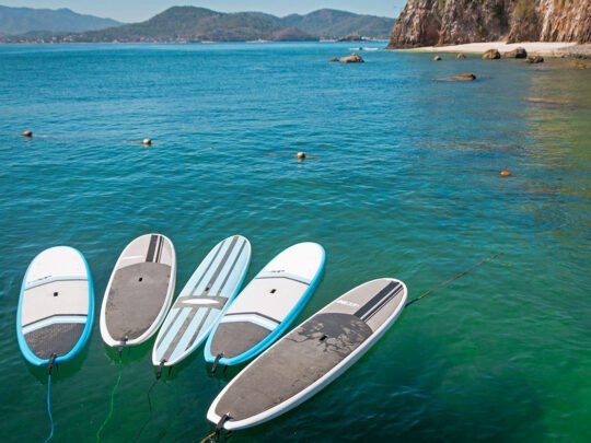 Multiple paddle boards floating on the ocean